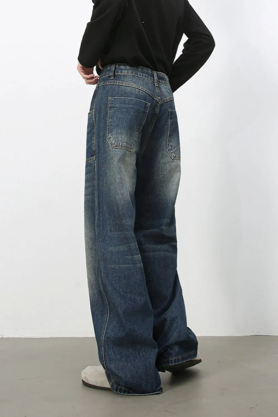 Medium wash wide-leg jeans with distressed details and a relaxed fit.