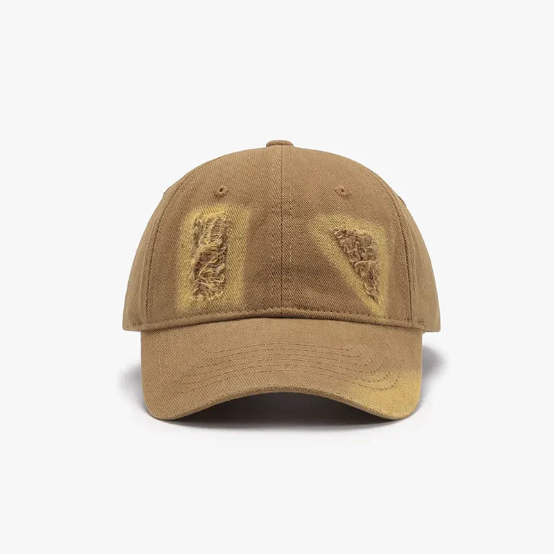 Camel distressed denim baseball cap with distressed patches and yellow accents.