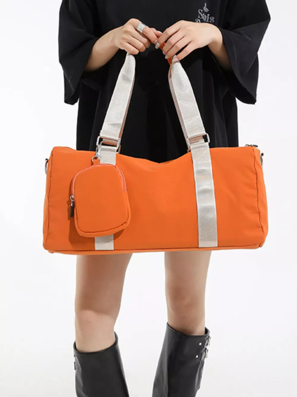 Orange duffle bag with detachable pouch and silver strap detail
