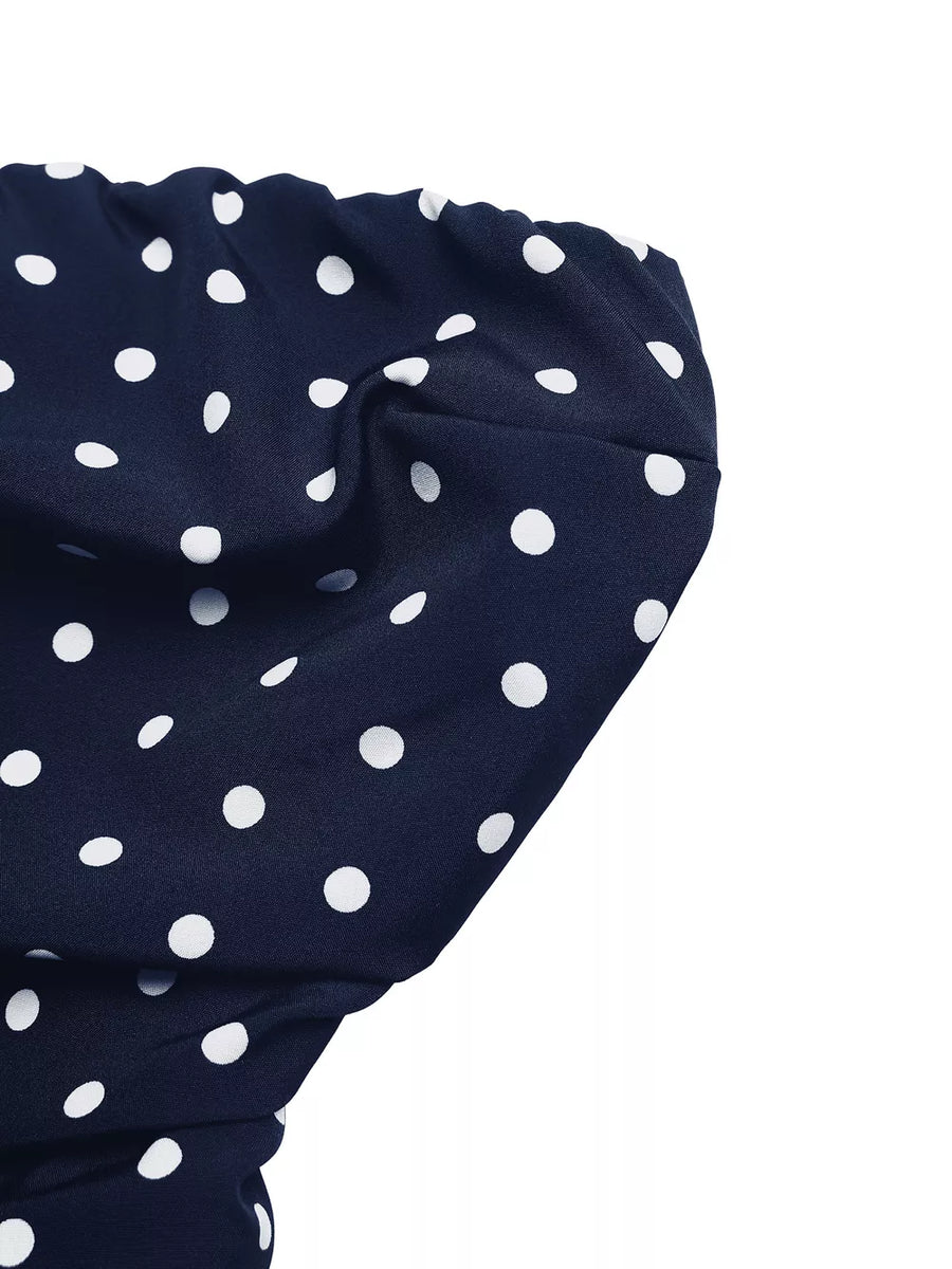 Navy polka dot A-line maxi dress detail showing fabric texture and pattern.