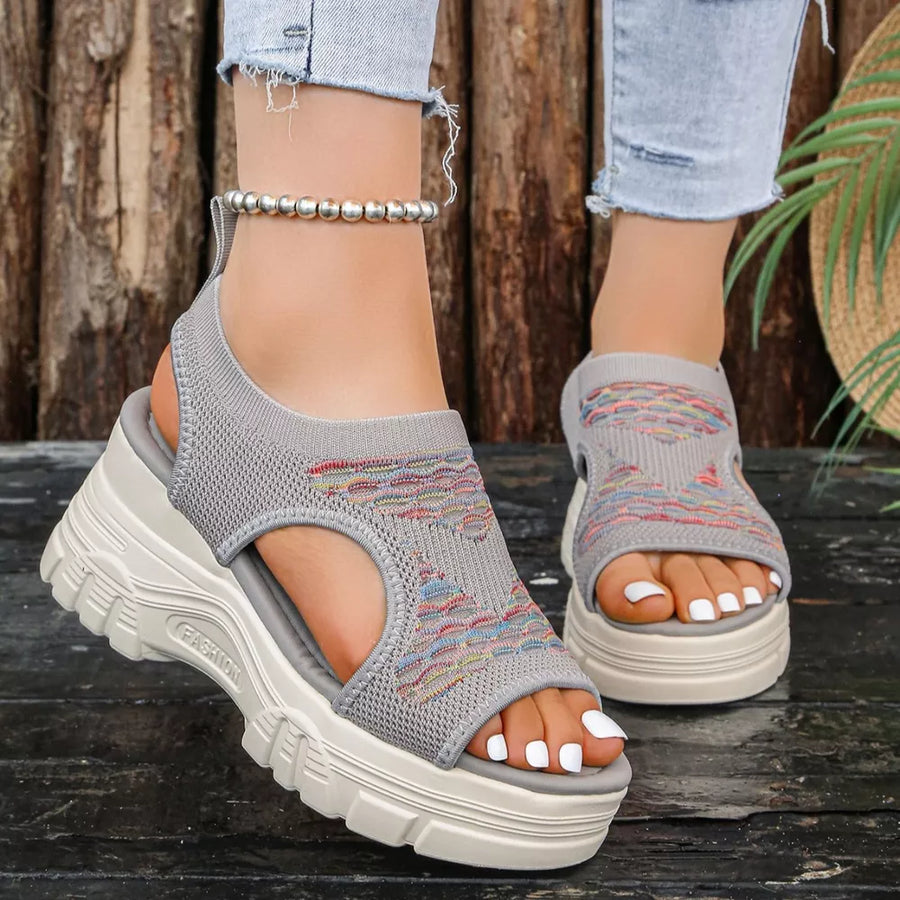 Gray knit platform sandals with colorful geometric pattern and open toe.