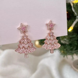 Festive Holiday Tree Earrings in blush pink with star tops, adorned with delicate shimmering stones.