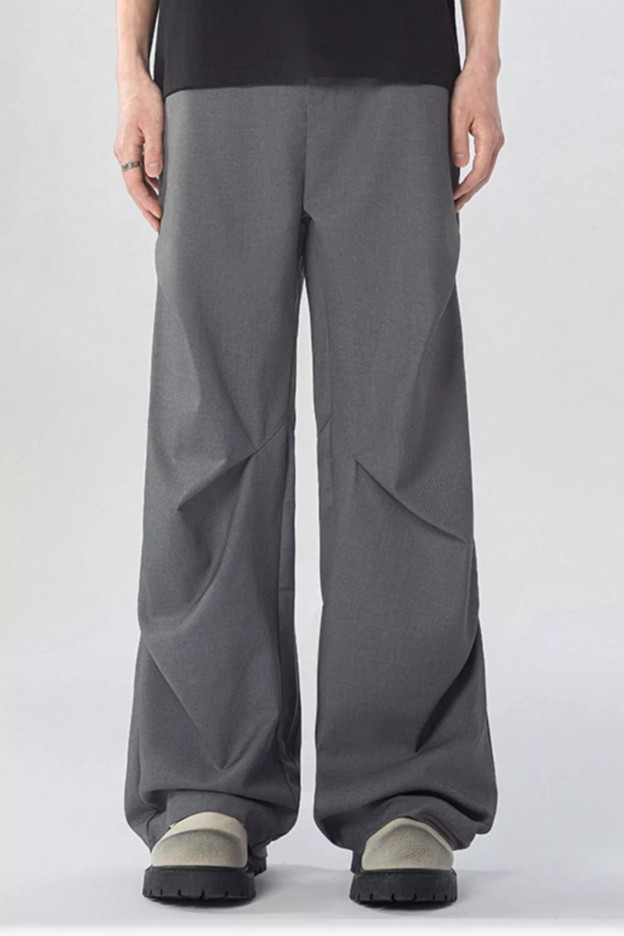 Men's gray wide-leg sweatpants with pockets and a relaxed fit.