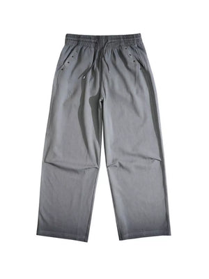 Men's grey wide-leg sweatpants with drawstring waist and pocket details.