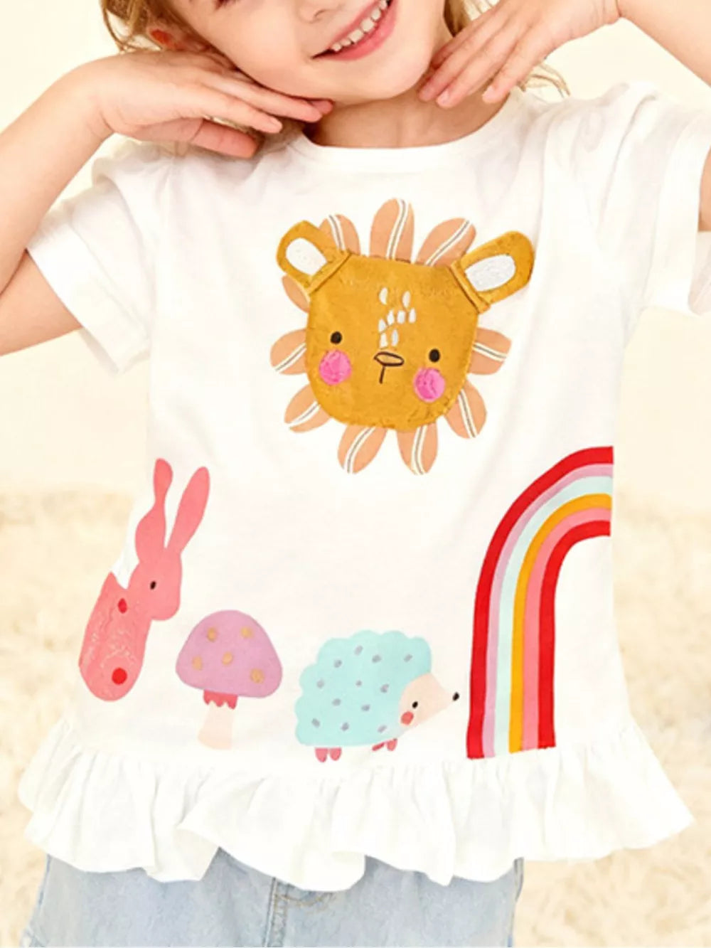 White cotton t-shirt with playful animal graphics, ruffle hem.