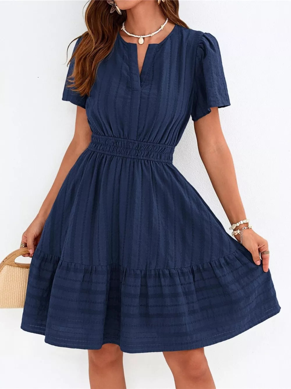 Textured navy tiered dress with V-neck and smocked waist