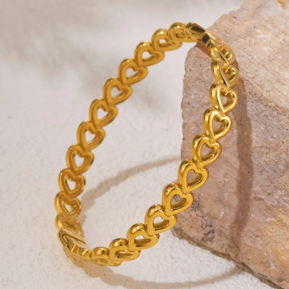 Gold heart motif chain bracelet with open heart charms