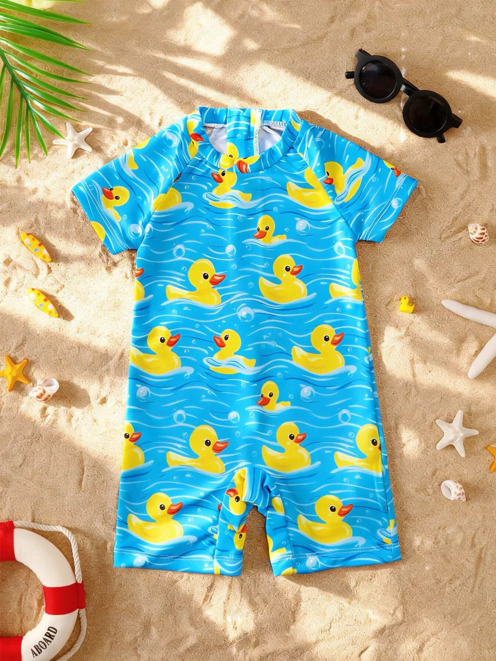 Baby one-piece swimsuit with short sleeves and a blue duck print pattern.