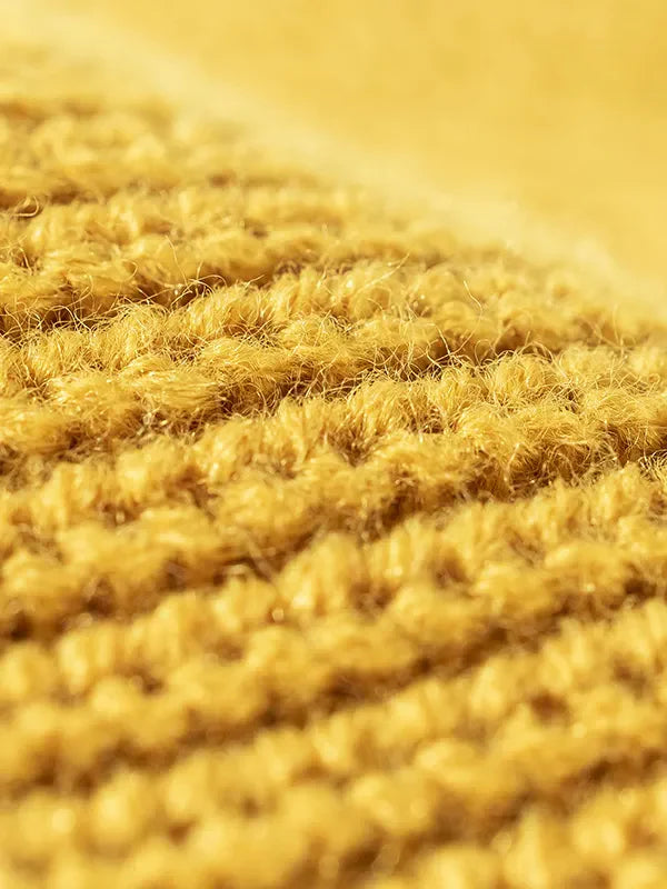 Yellow ribbed knit beanie with distressed texture detail