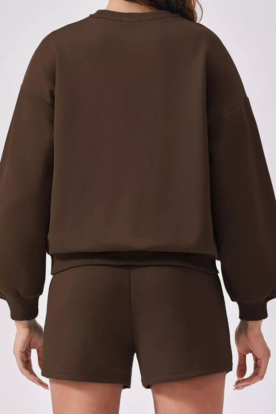 Cozy two-piece sweatshirt set in dark brown, featuring balloon sleeves and comfortable shorts.