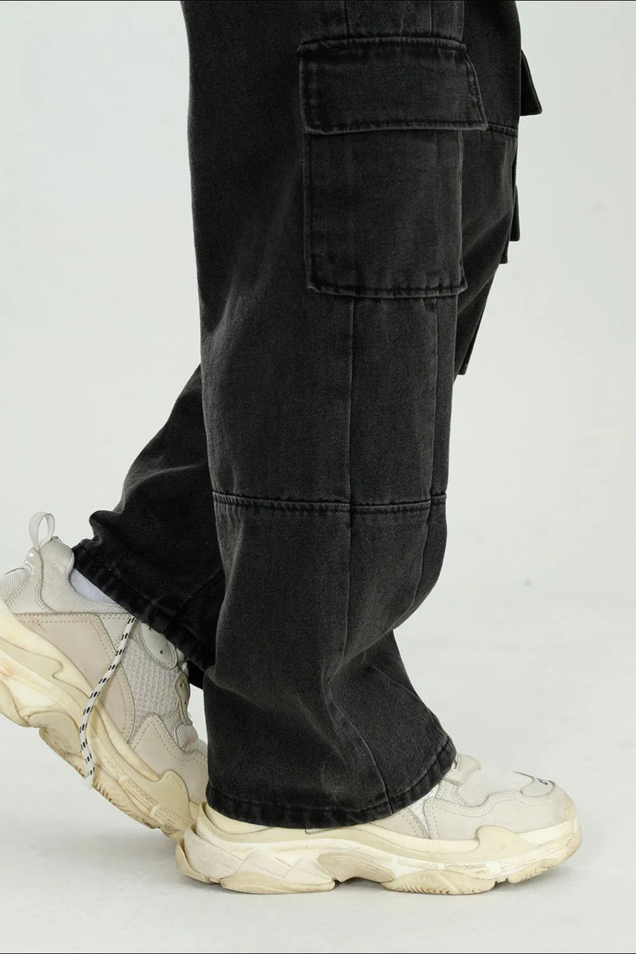 Black washed denim utility cargo pants with large side pockets.