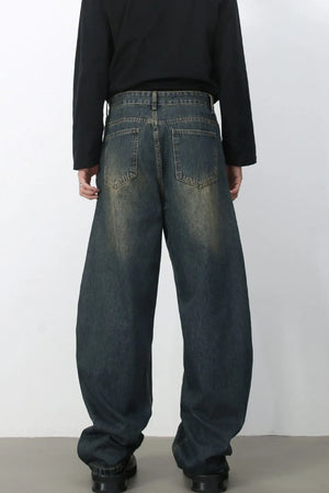 Faded baggy denim jeans in a dark blue wash with a relaxed fit.