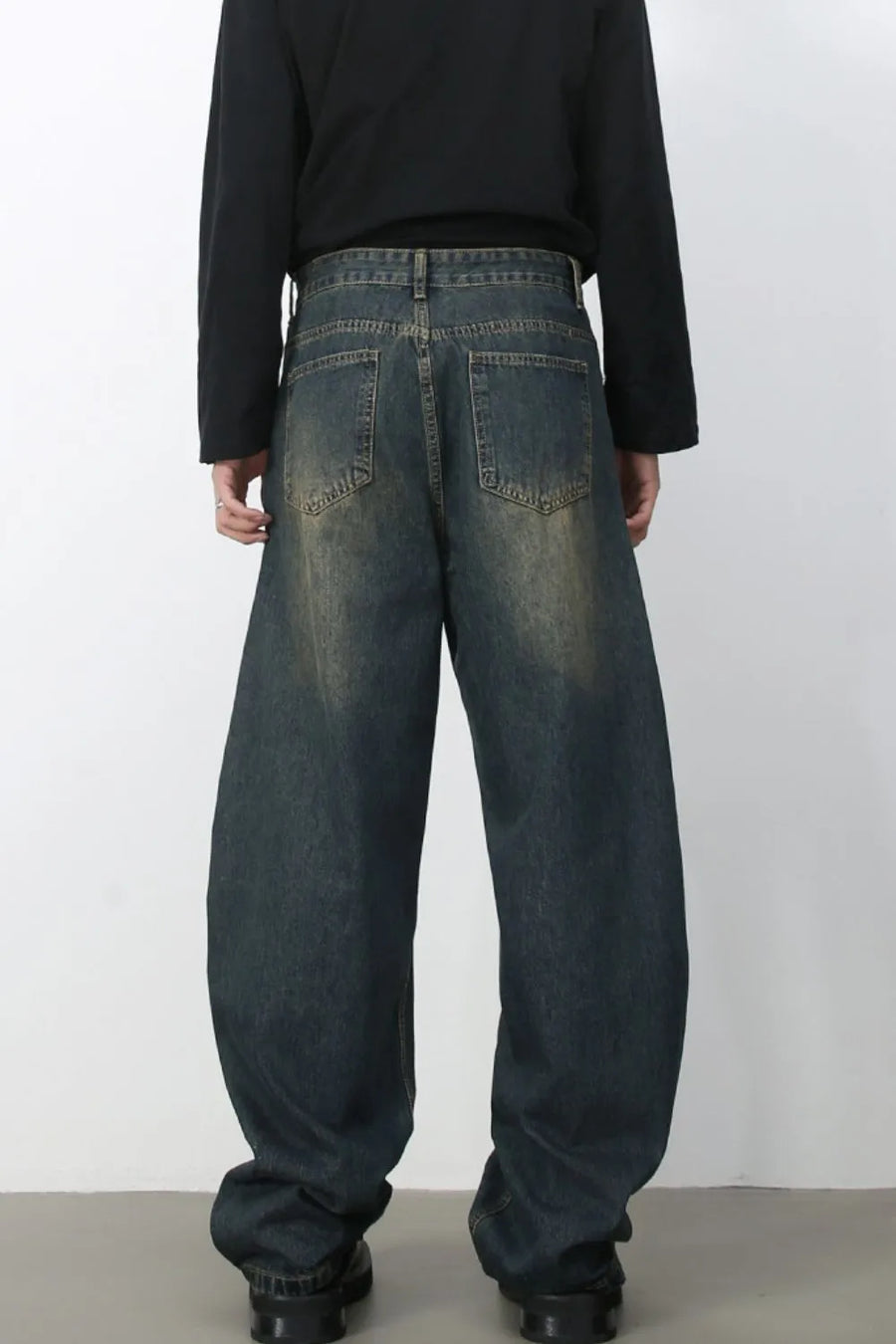 Faded baggy denim jeans in a dark blue wash with a relaxed fit.