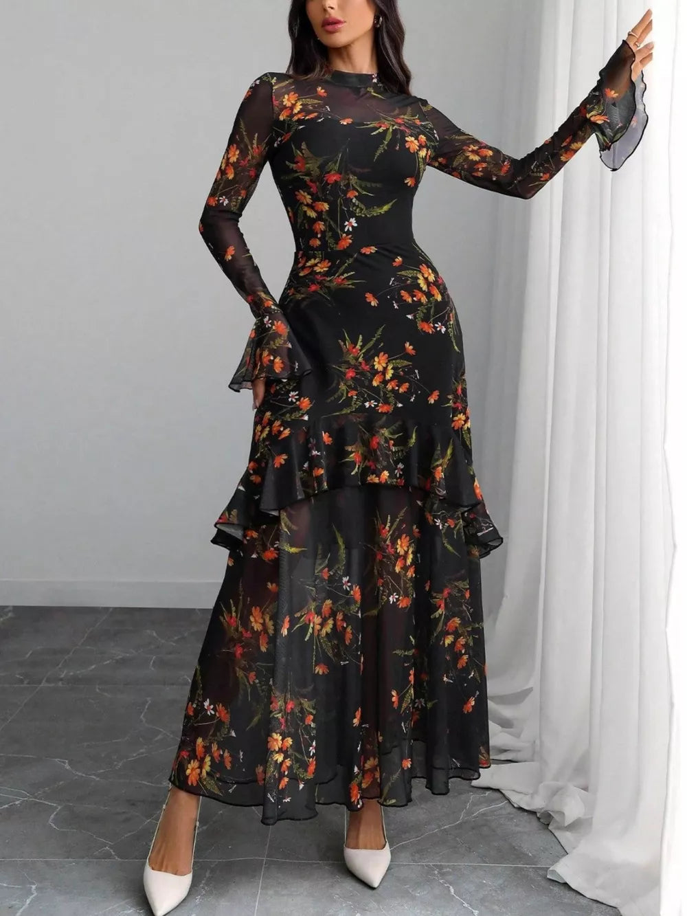 Black floral mermaid maxi dress with sheer flounce sleeves and tiered ruffles.