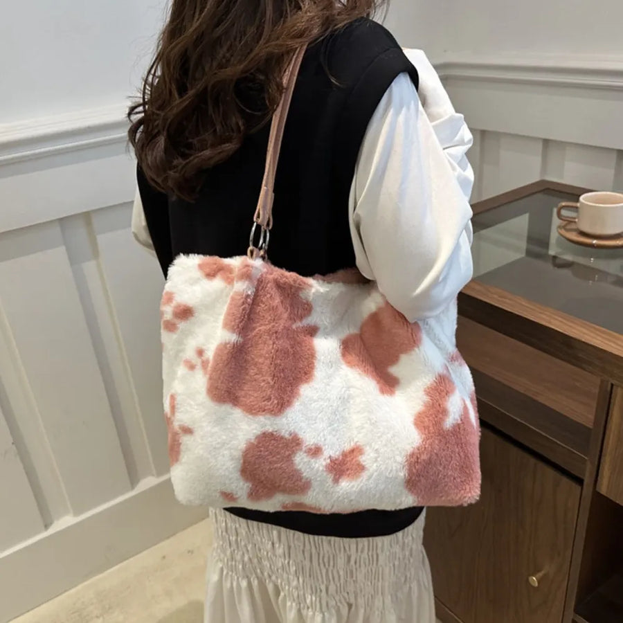 Dusty pink and white cowhide print faux fur shopper bag with pink strap.