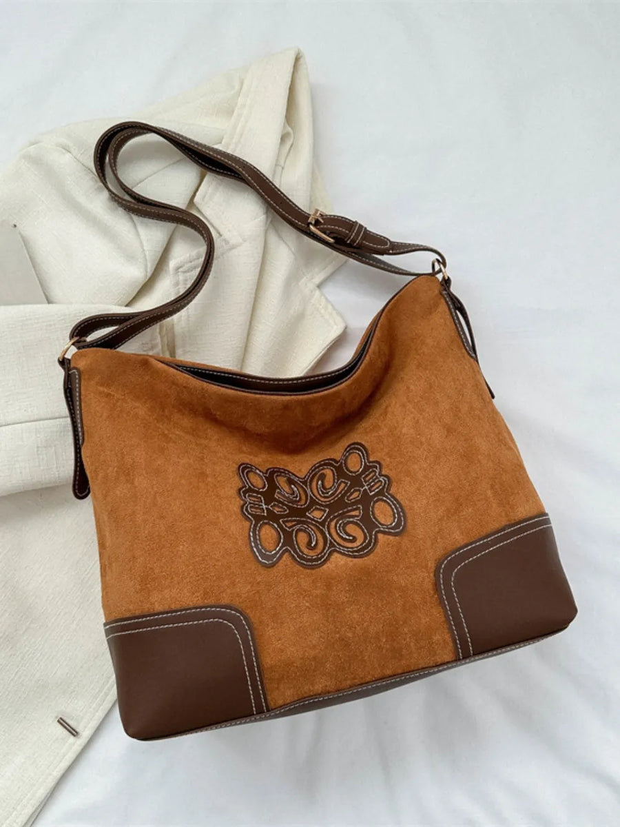 Ochre suede hobo bag with brown leather trim, appliqué detail and contrast stitching.