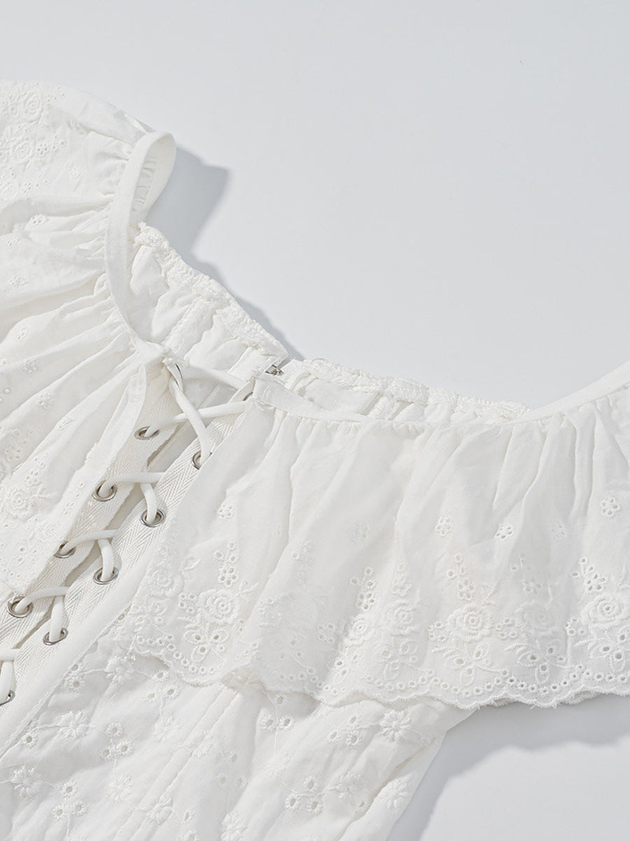 White eyelet lace-up corset tank top with ruffle trim and delicate floral embroidery.