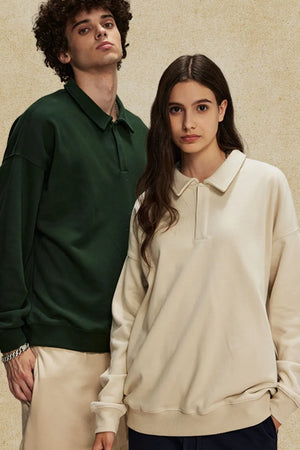 Oversized polo sweatshirt in tan and dark green with collar and button placket.