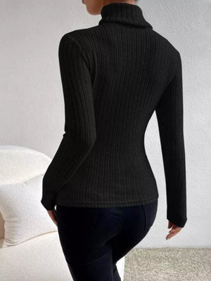 Black ribbed turtleneck long sleeve tee with a fitted silhouette.