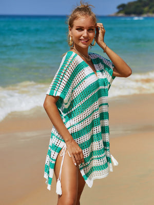Striped crochet beach cover-up in turquoise and white with V-neck, short sleeves, and drawstring sides with tassels.