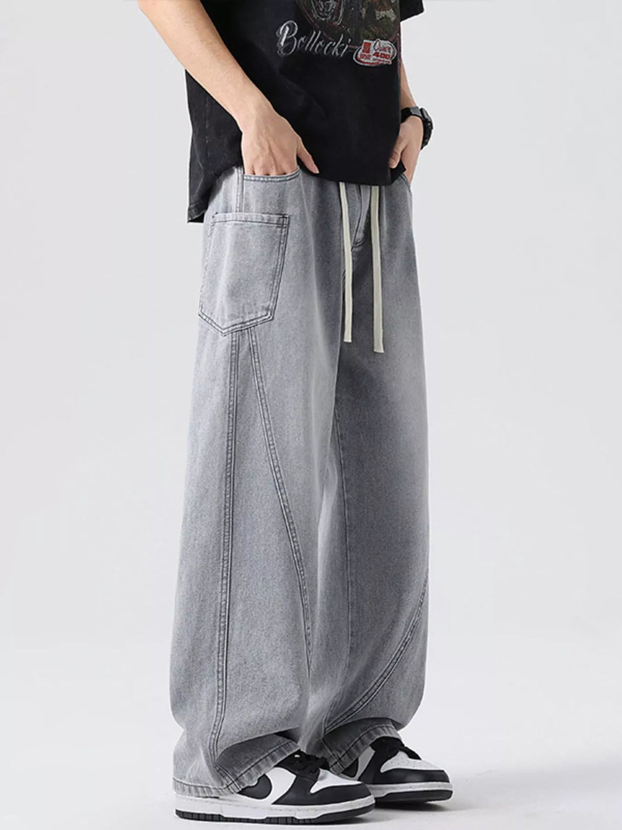 Oversized wide-leg jeans in Smoky Gray denim with drawstring and front seam detail.