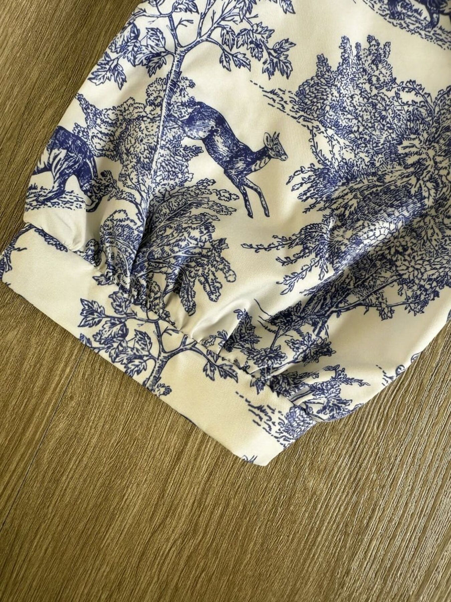 White Toile De Jouy half sleeve blouse with blue deer and tree print, featuring a gathered cuff detail.