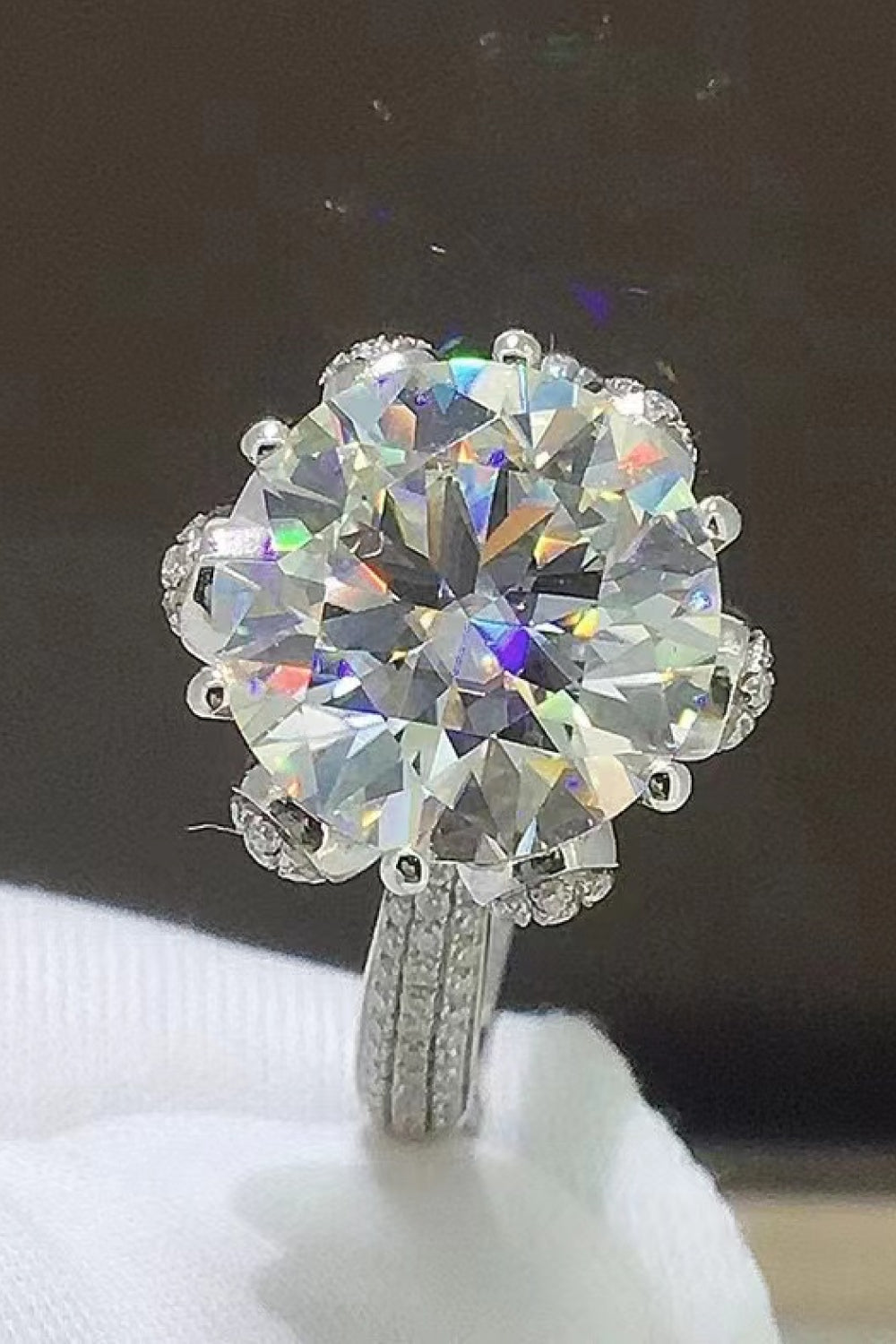 Sparkling Aura Moissanite Ring in silver with a large center stone and pavé band.