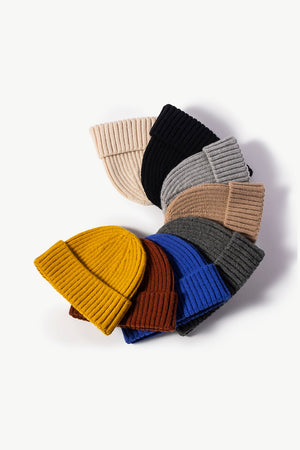 Chunky ribbed knit beanies in mustard, brown, blue, gray, tan, black, and cream.