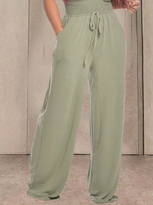 Sage green wide leg pants with smocked waist and drawstring detail