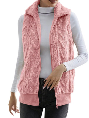 Pink faux fur zip-up vest with textured pattern and ribbed hem.