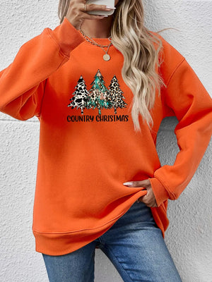 Orange graphic sweatshirt with country Christmas trees and text, crewneck, long sleeves