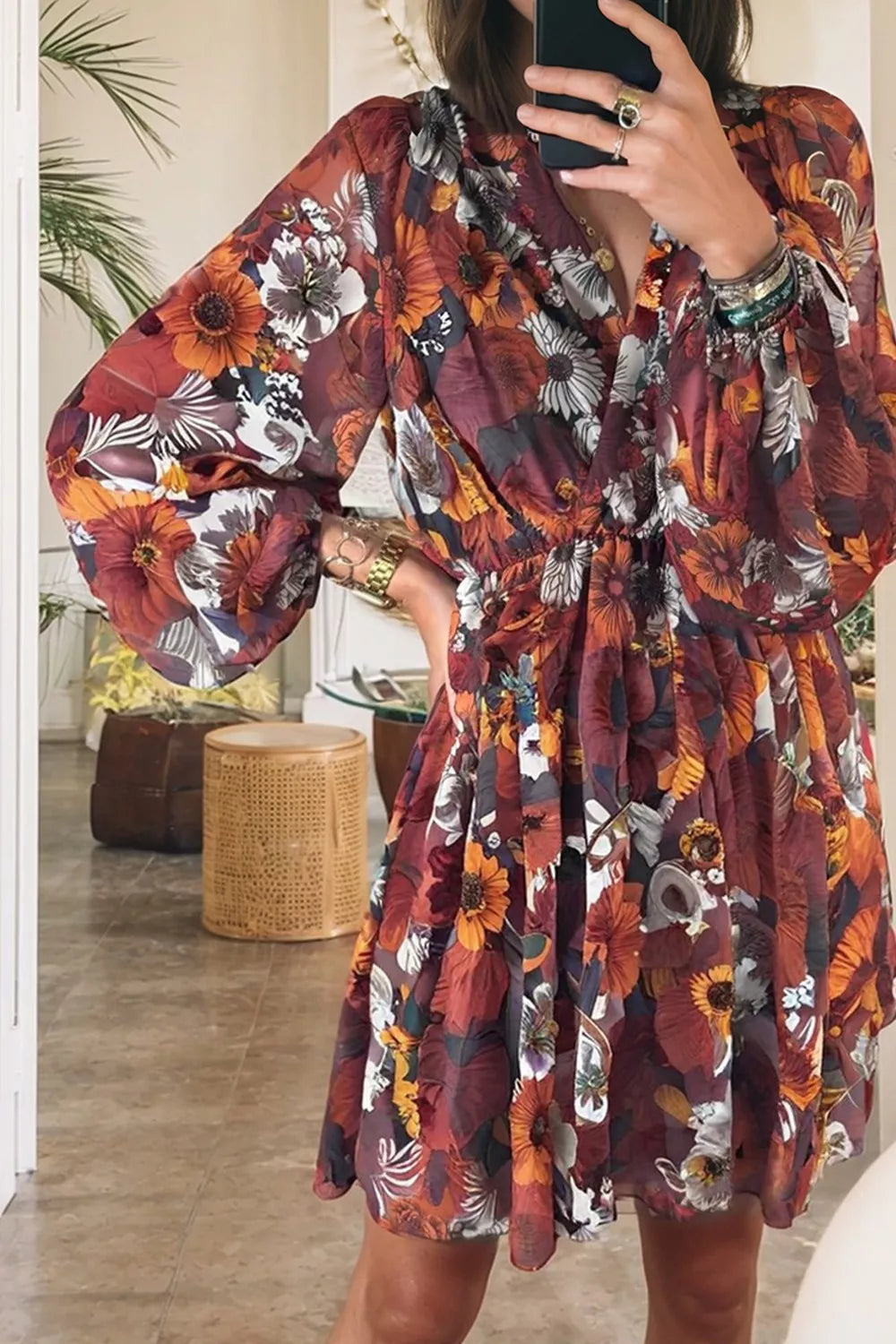 Floral balloon sleeve mini dress with a deep V-neck and cinched waist.