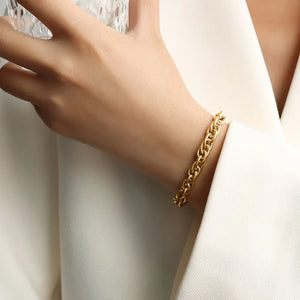 Textured rope chain bracelet in gold with a twisted link design.