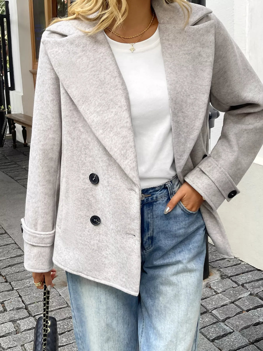 Wool blend double-breasted overcoat in light grey with two button closure and cuffed sleeves.