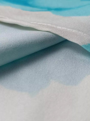 Teal floral print maxi dress detail showing ruffle sleeve fabric texture