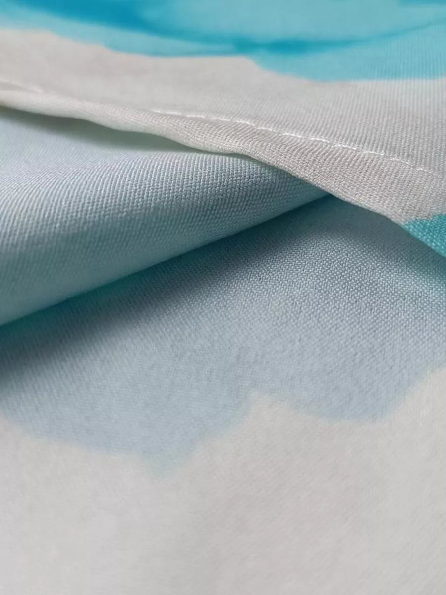 Teal floral print maxi dress detail showing ruffle sleeve fabric texture