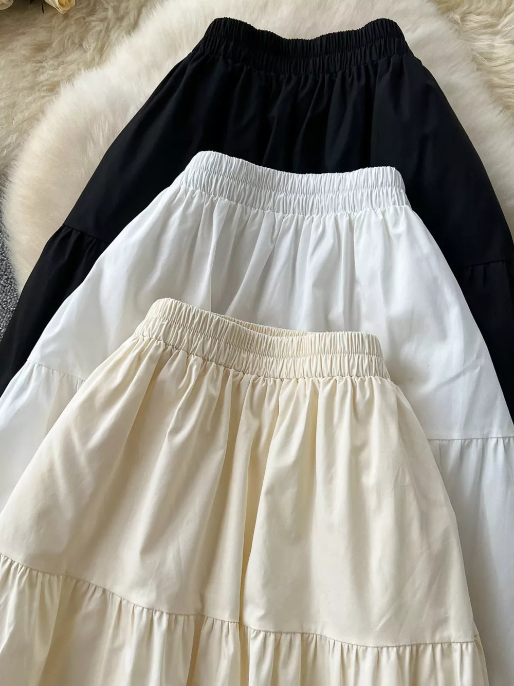 Tiered lace detail skirt with elastic waist in black and apricot.