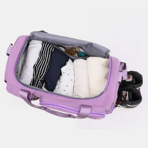 Purple canvas duffel bag packed with clothes and toiletries, side shoe compartment.