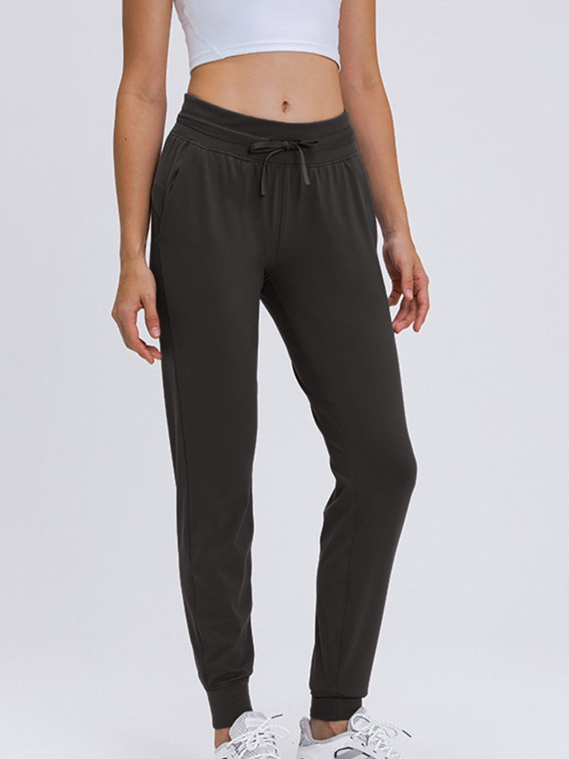 Dark gray drawstring cuffed joggers with pockets and elastic waistband