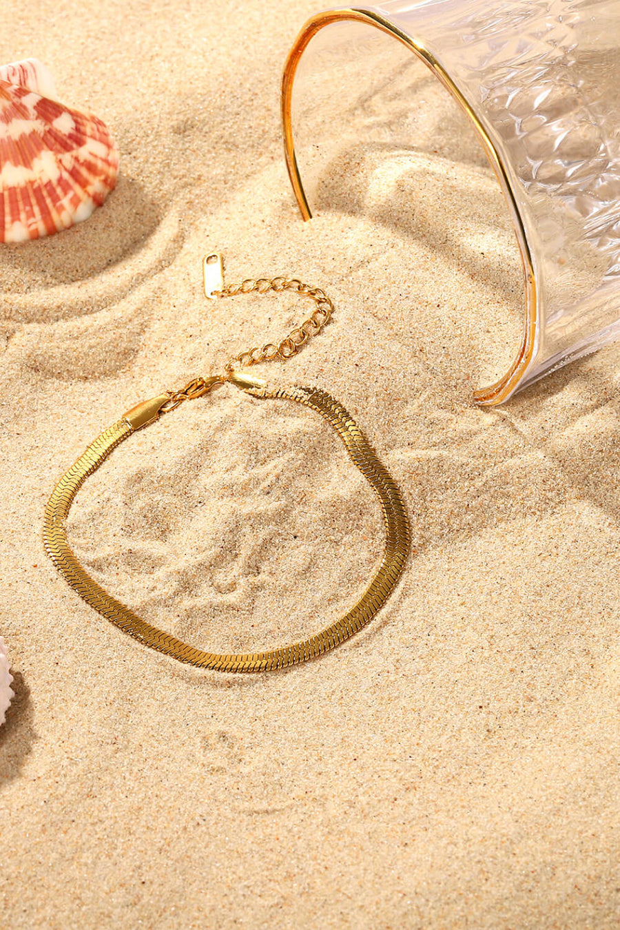 Gold herringbone chain bracelet with adjustable clasp detail.