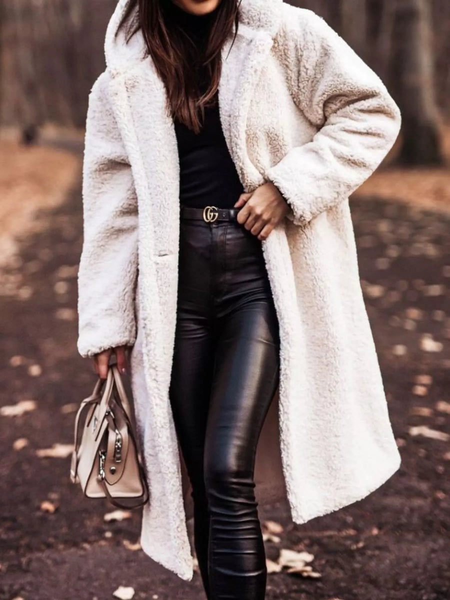 Creamy-white teddy bear longline coat with hood, buttoned front, and pockets.