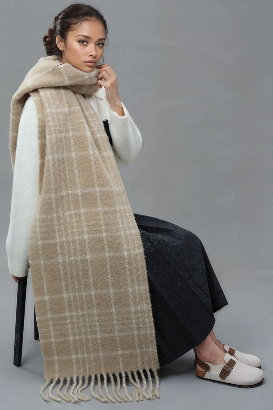 Textured plaid fringed scarf in tan with a cozy, brushed finish.
