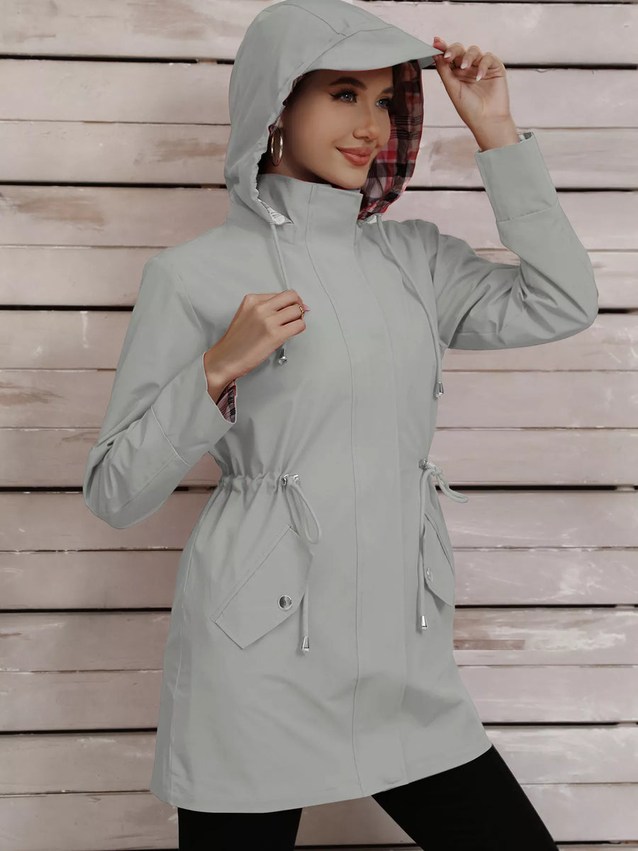 Light gray drawstring trench coat with plaid lining and hood.