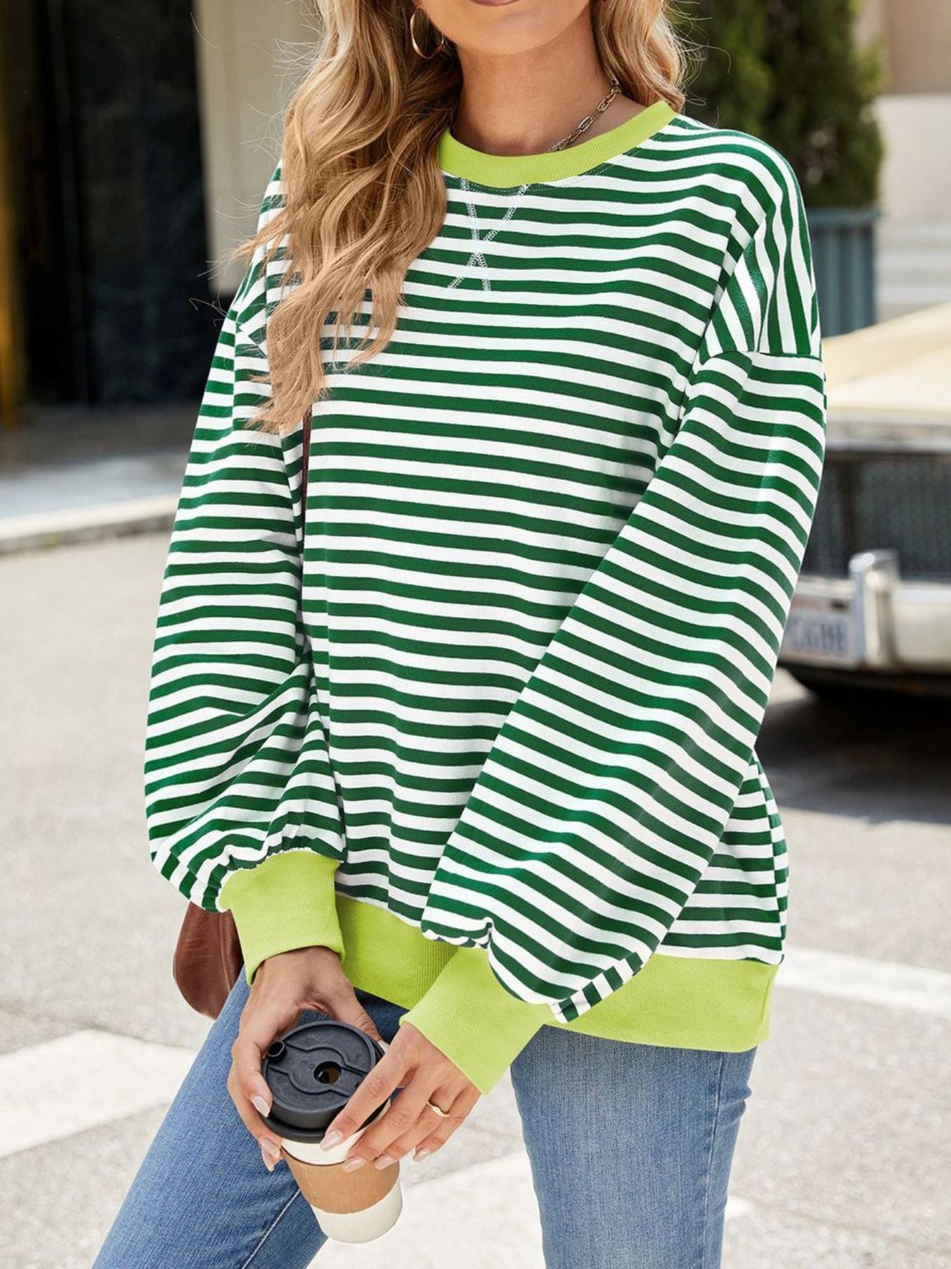 Striped crew neck sweatshirt in green and white with contrasting lime green cuffs and neckline.
