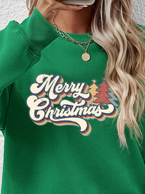 Green crewneck sweatshirt with Merry Christmas graphic and festive trees.