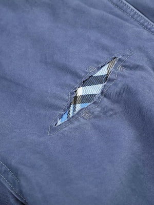Blue maternity cargo capris with distressed detailing and plaid underlay.