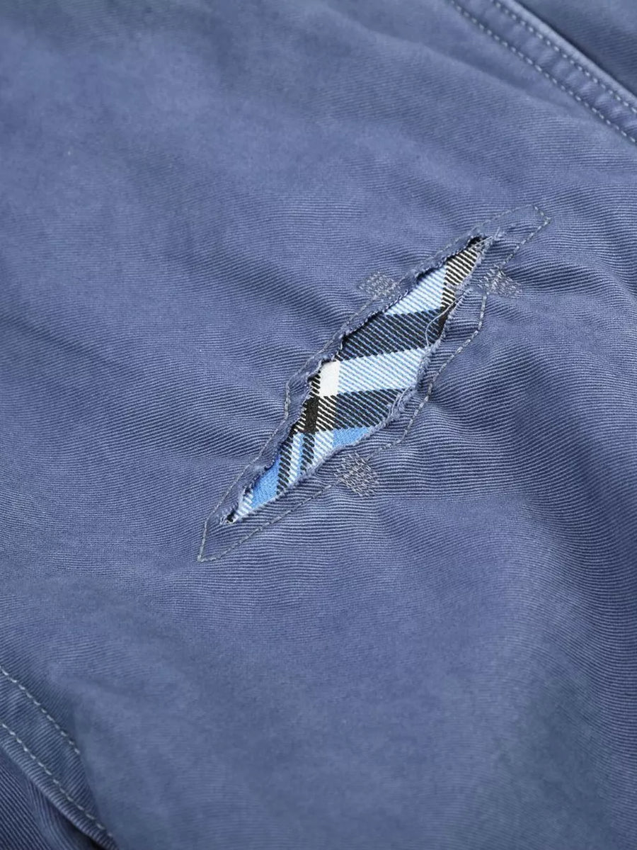 Blue maternity cargo capris with distressed detailing and plaid underlay.