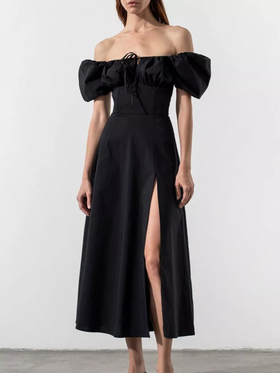 Black puff sleeve tie front midi dress with off-shoulder neckline and thigh-high slit.