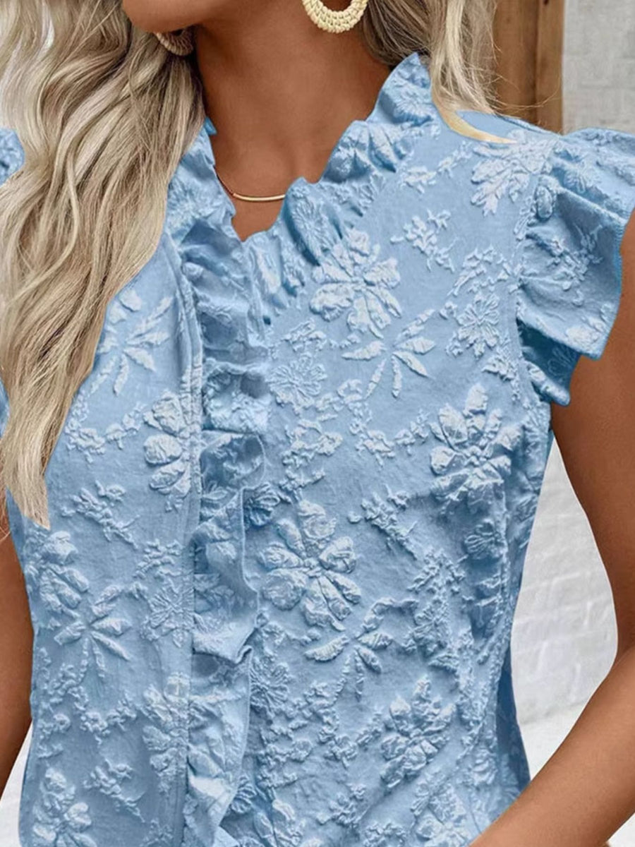 Light blue floral embossed ruffle blouse with short sleeves and frill detail.