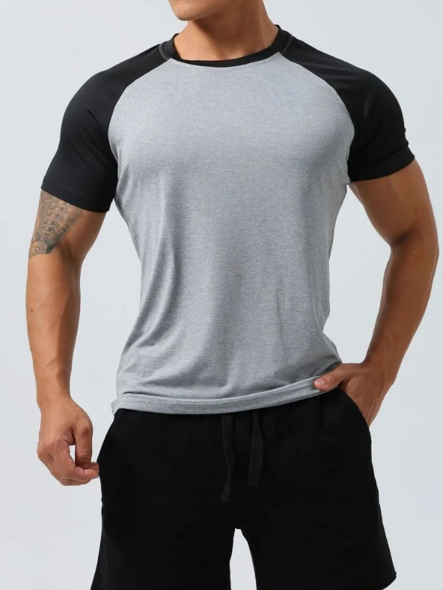 Raglan sleeve performance tee in light gray with black sleeves and neckline.